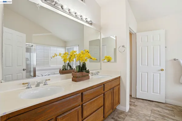a bathroom with a double vanity sink and a mirror
