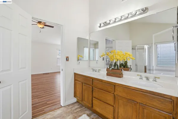a bathroom with a double vanity sink a mirror and shower