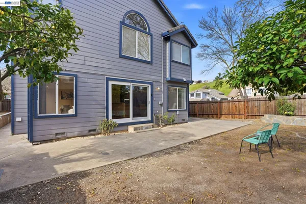 a brick house with table and chairs in front of it