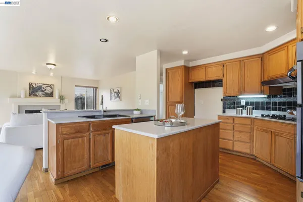 a kitchen with stainless steel appliances granite countertop a sink stove and wooden cabinets