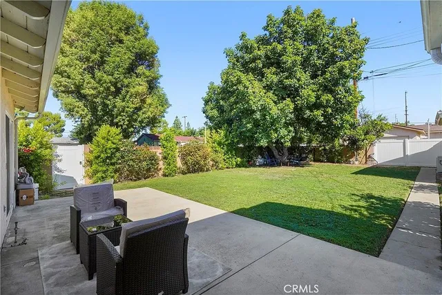 a view of a backyard with sitting area
