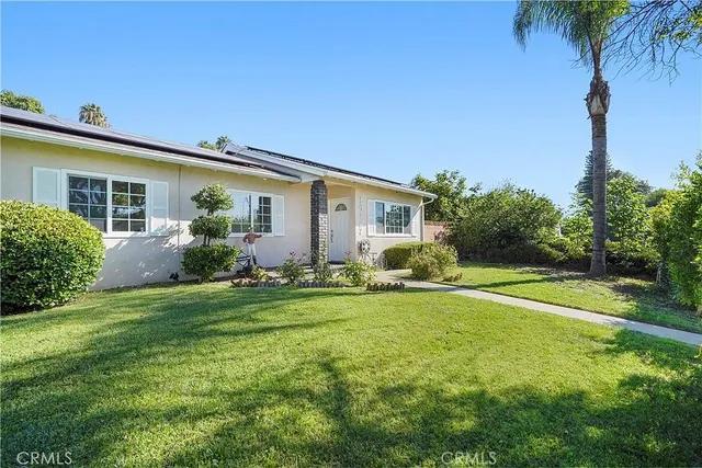 a front view of house with yard and outdoor seating