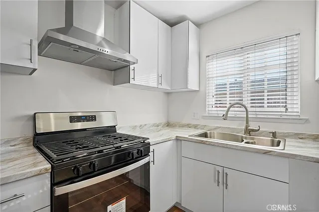 a kitchen with a sink stove and cabinets