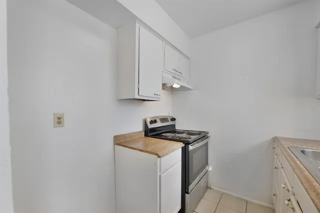 a utility room with wooden floor washer and dryer