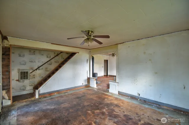 an empty room with windows and closet