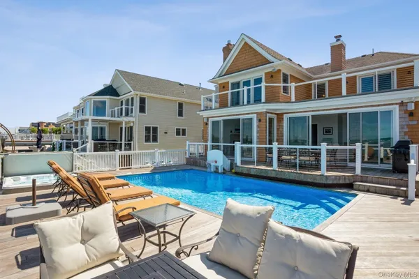 a view of a building with swimming pool and sitting area