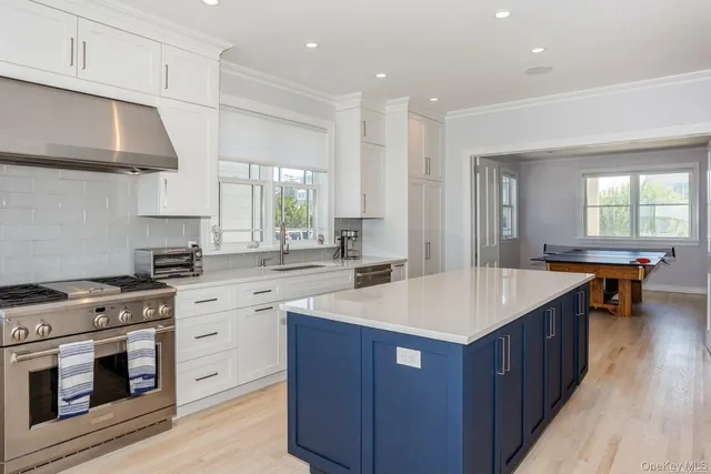 a kitchen with a sink stove and cabinets