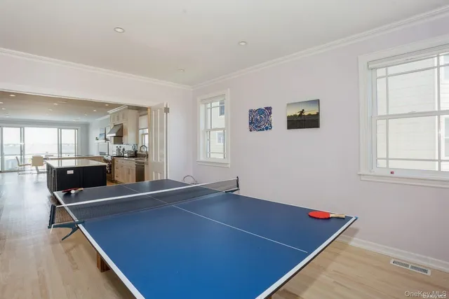 a room with pool table and windows