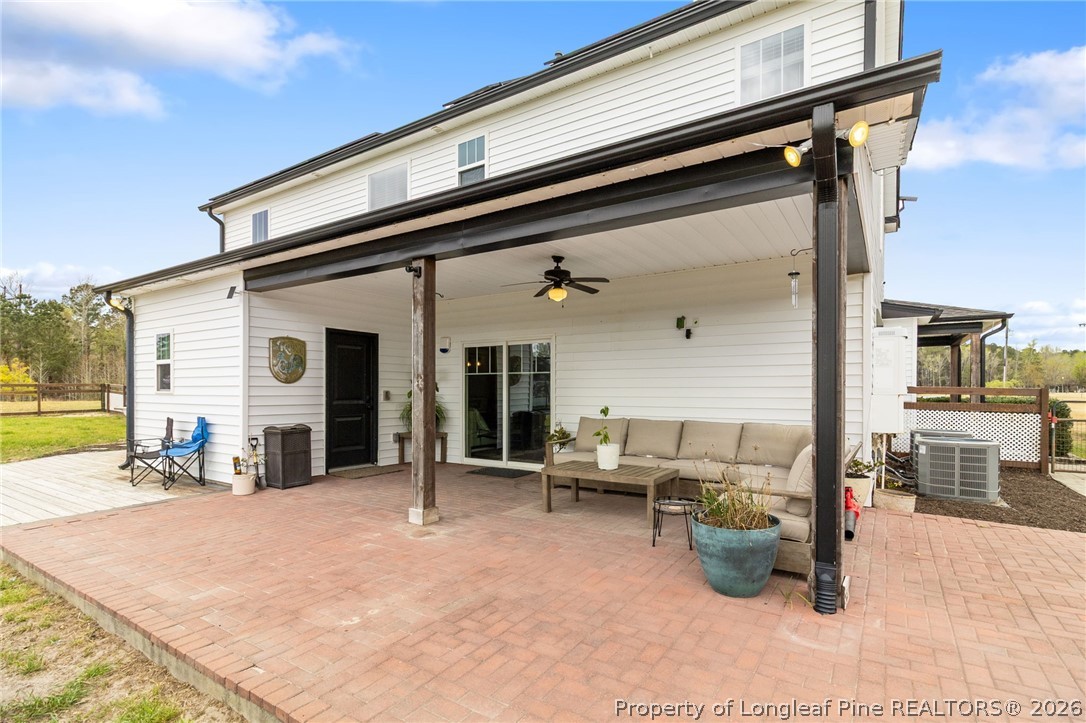 5535 Butler Nursery Road Fayetteville, NC 28306 - Photo 38 of 50 a view of a patio with a table and chairs under an umbrella