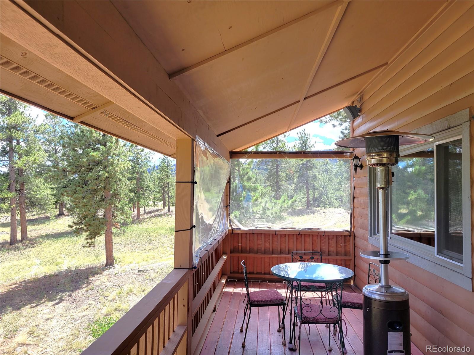5076 Campfire Road Hartsel, CO 80449 - Photo 14 of 35 a view of a porch with furniture and wooden deck