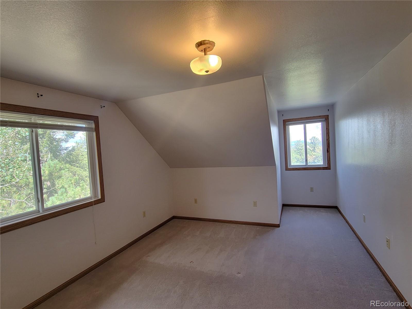 5076 Campfire Road Hartsel, CO 80449 - Photo 17 of 35 an empty room with windows and closet