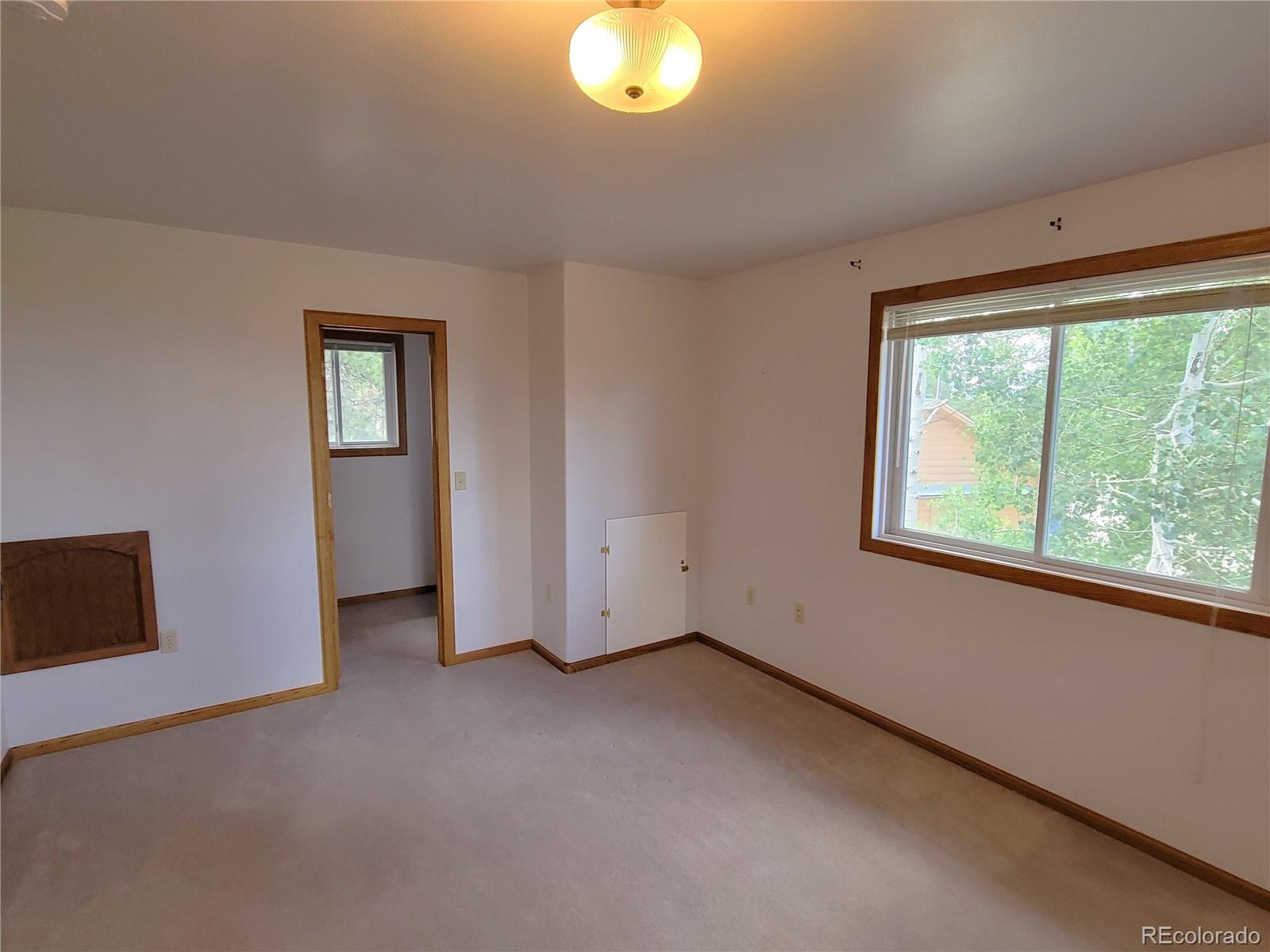 5076 Campfire Road Hartsel, CO 80449 - Photo 18 of 35 an empty room with windows and closet