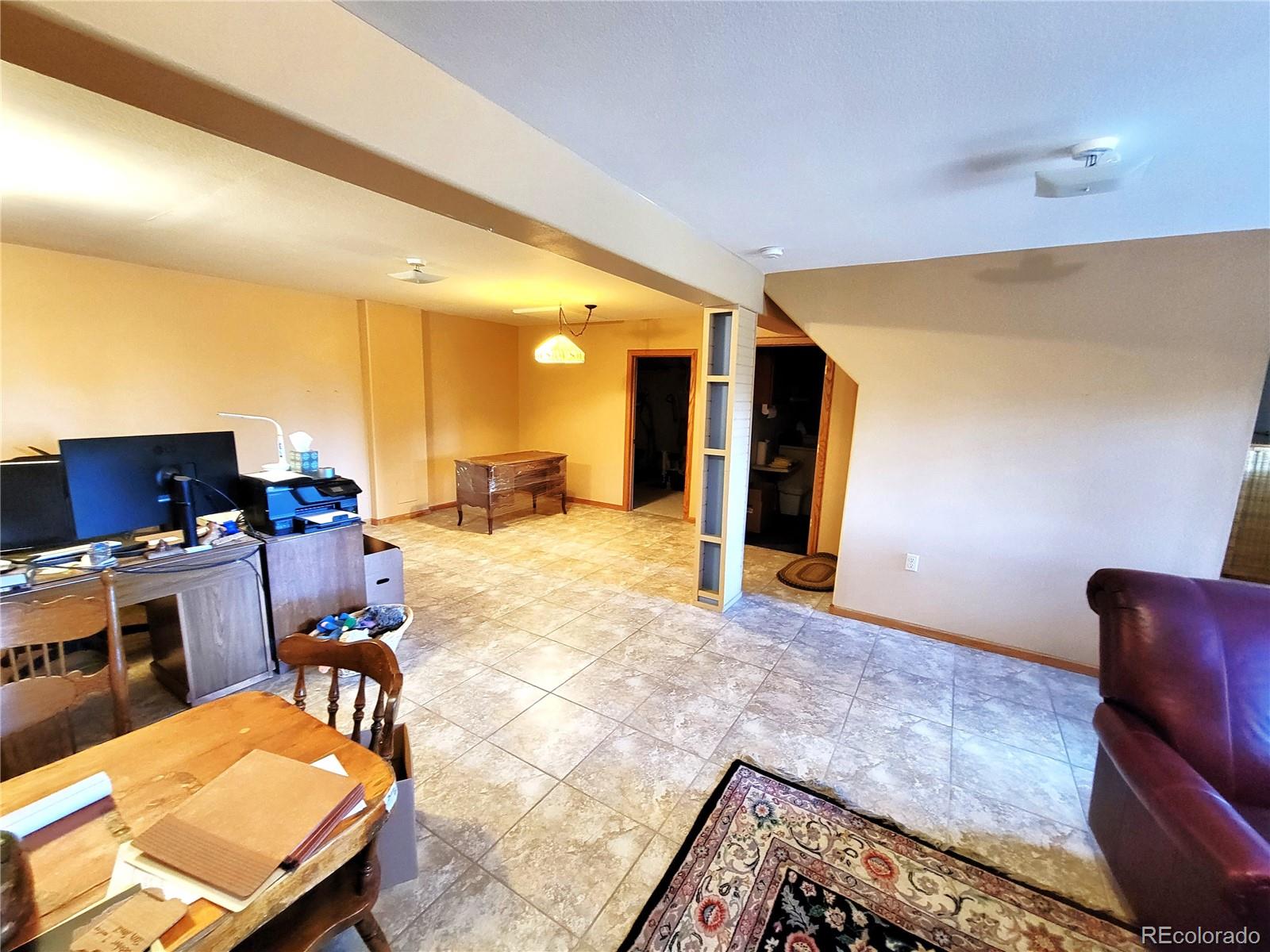 5076 Campfire Road Hartsel, CO 80449 - Photo 20 of 35 a workspace with furniture and a rug