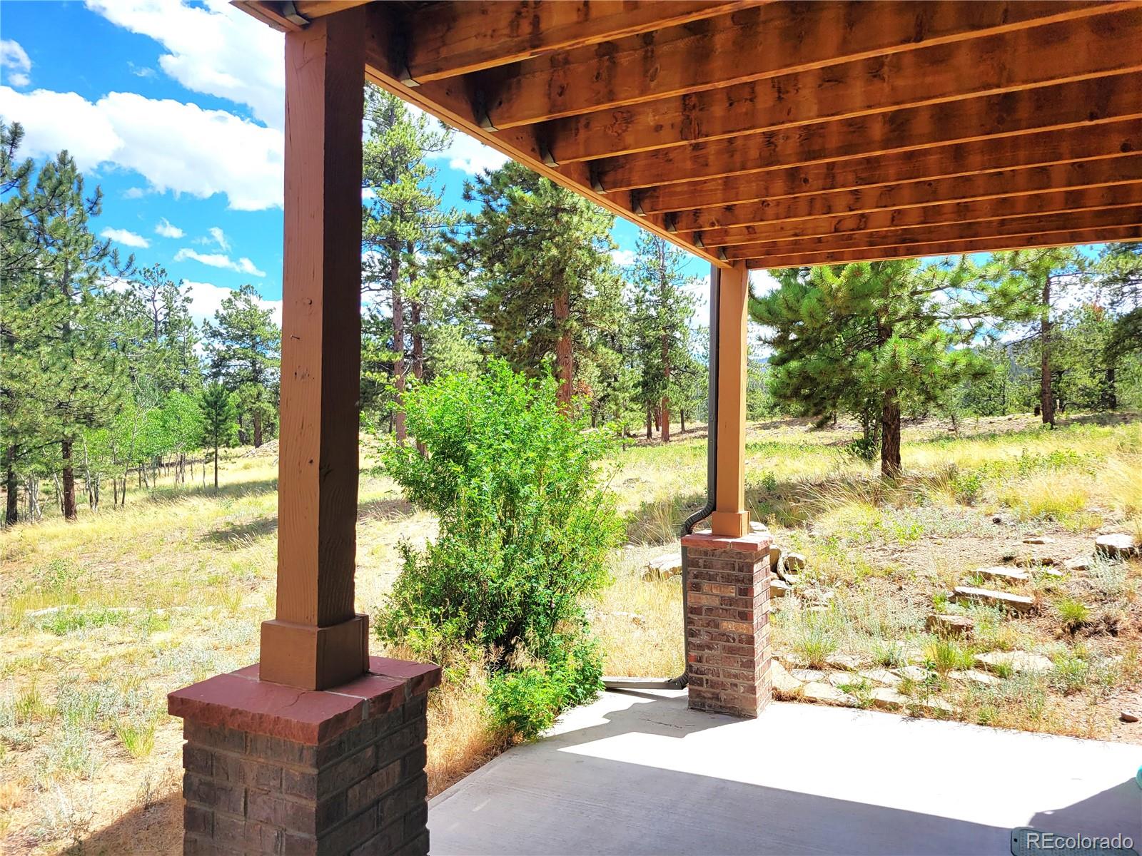 5076 Campfire Road Hartsel, CO 80449 - Photo 23 of 35 a front view of a house with a garden