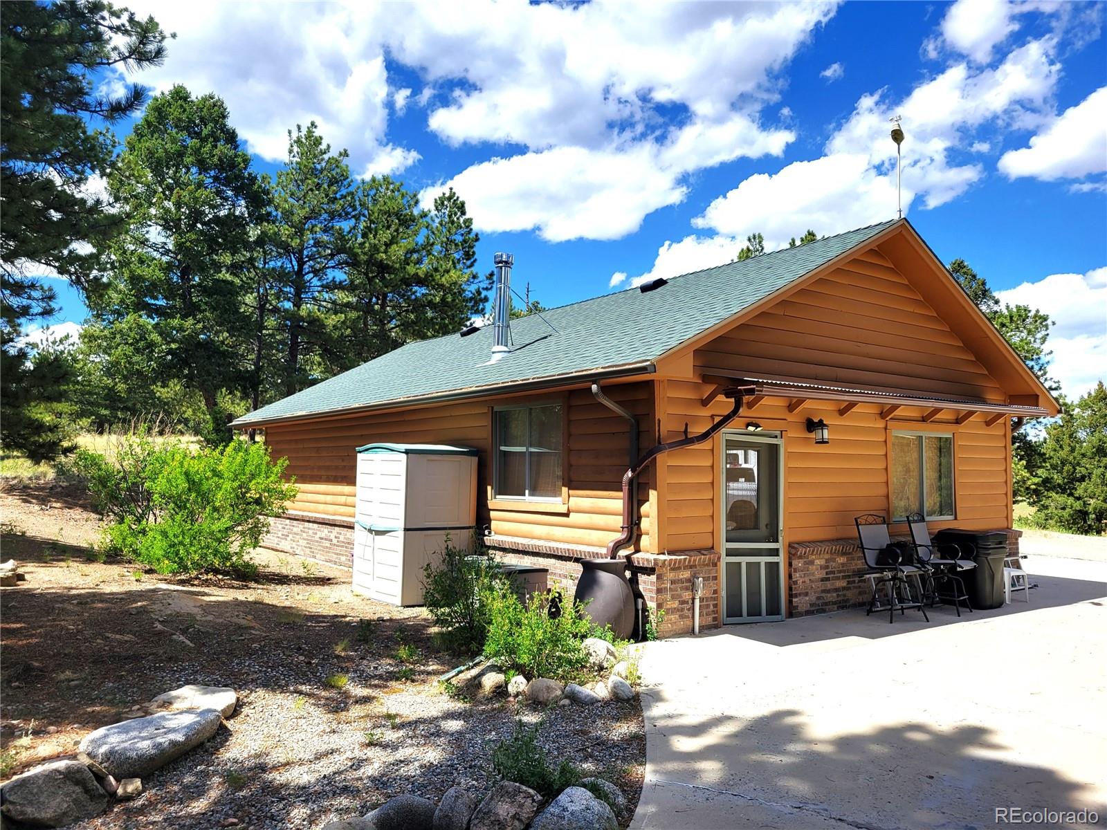 5076 Campfire Road Hartsel, CO 80449 - Photo 25 of 35 a front view of a house with a yard covered in snow