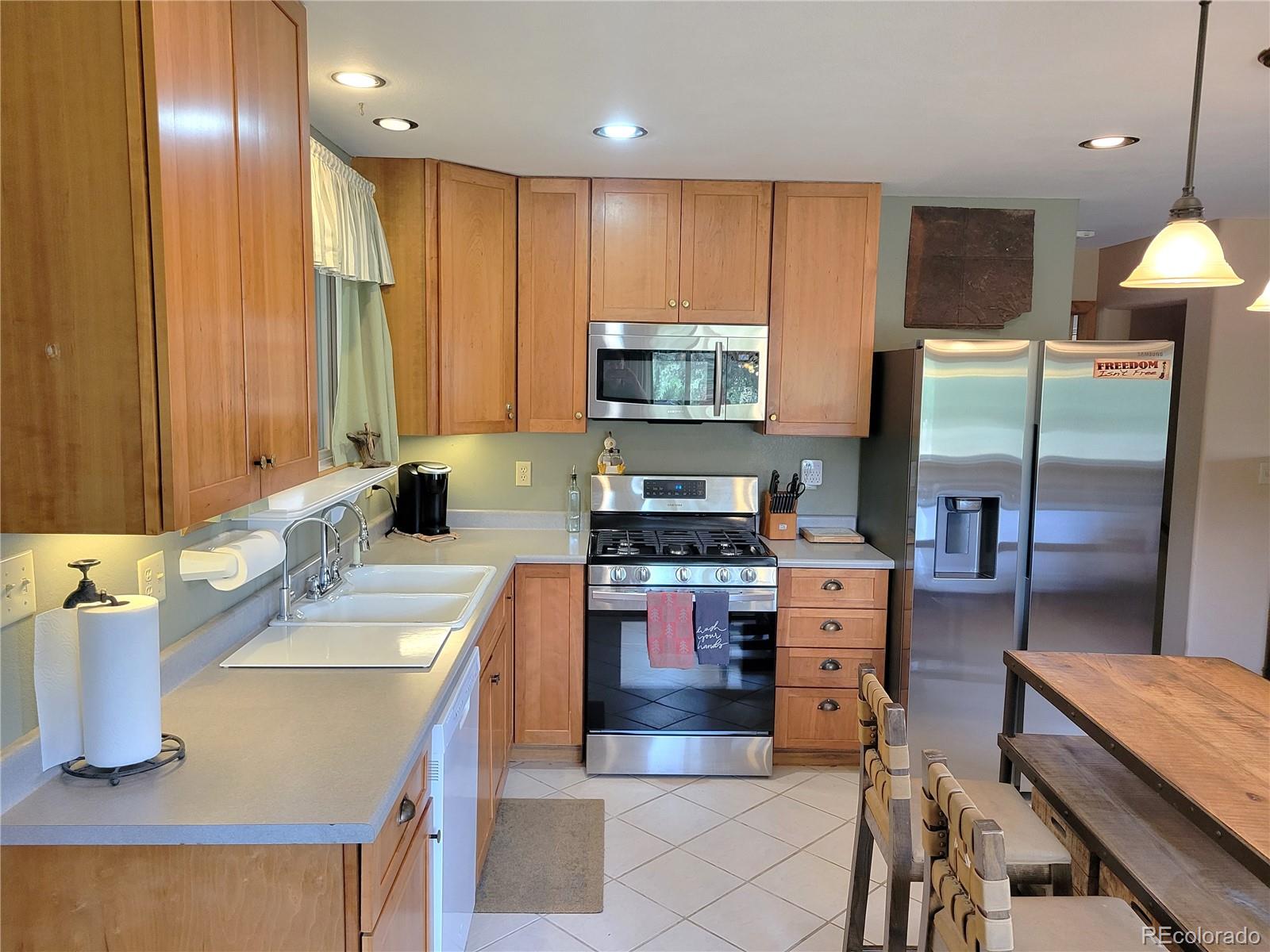 5076 Campfire Road Hartsel, CO 80449 - Photo 7 of 35 a kitchen with stainless steel appliances granite countertop a sink stove and refrigerator