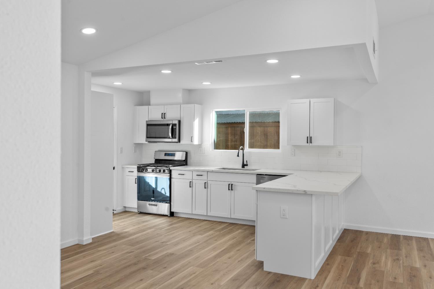 1509 Boothe Road Ceres, CA 95307 - Photo 12 of 28 a kitchen with granite countertop a sink stove and refrigerator