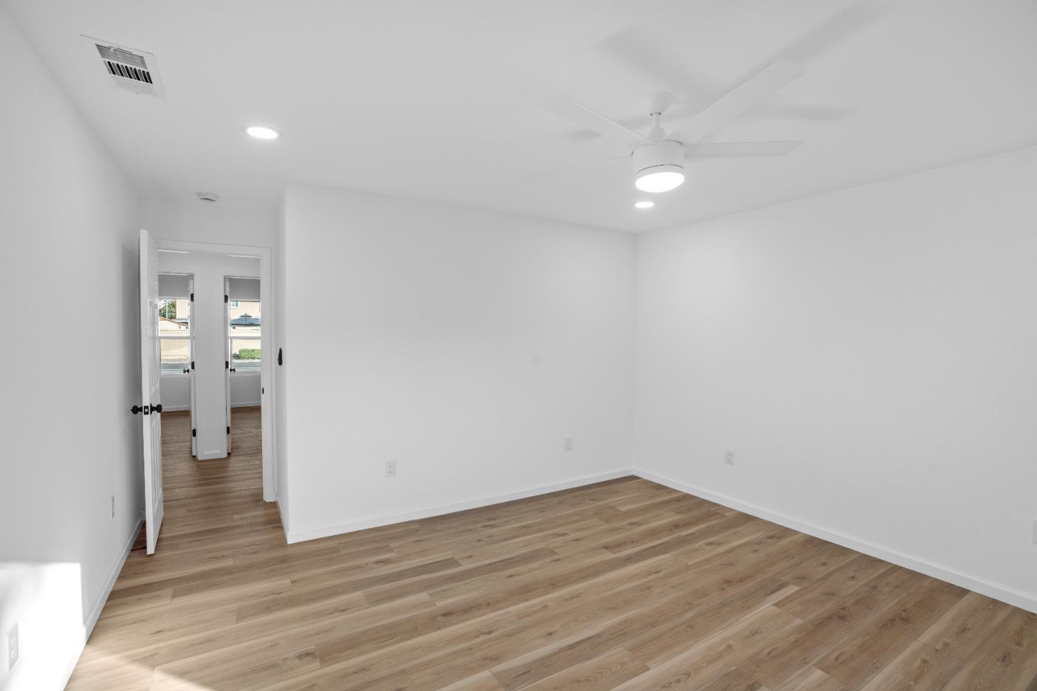 1509 Boothe Road Ceres, CA 95307 - Photo 18 of 28 a view of empty room with wooden floor