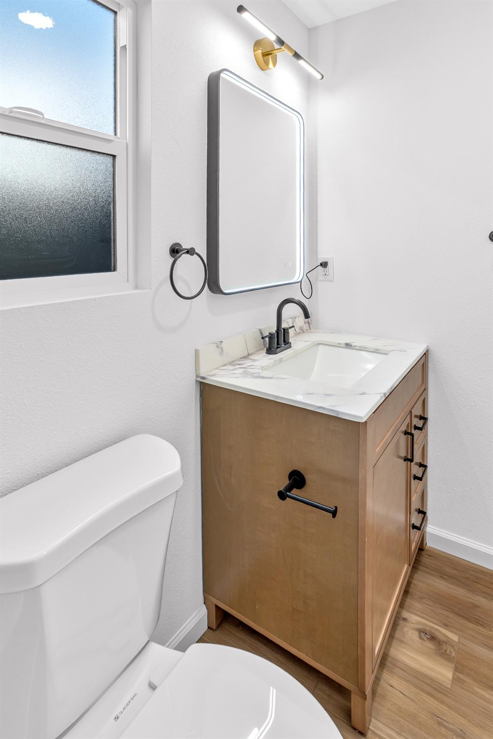 1509 Boothe Road Ceres, CA 95307 - Photo 25 of 28 a bathroom with a toilet sink and mirror