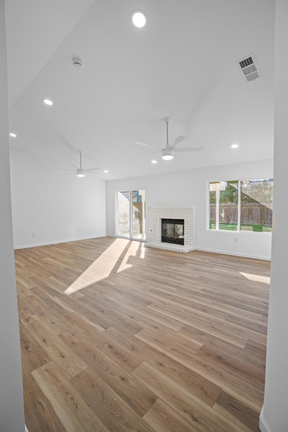 1509 Boothe Road Ceres, CA 95307 - Photo 4 of 28 a view of an empty room with a window and a kitchen