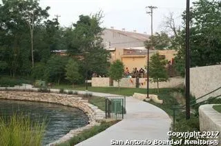 a view of swimming pool with a patio and couches chairs