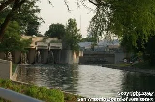 a view of trees and flowers from the window