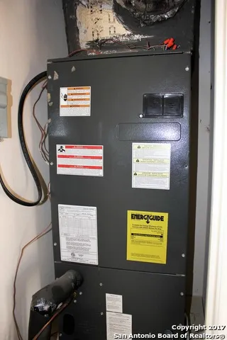 a view of a kitchen with wooden floor and a ceiling fan