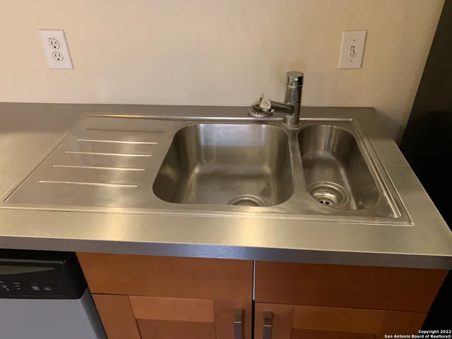 a view of a livingroom with a stove and a refrigerator