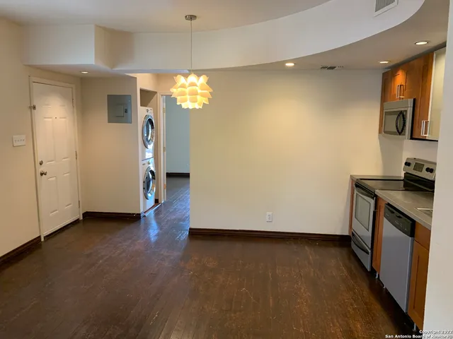an empty room with wooden floor and a window