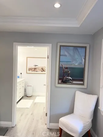 a living room with a toilet and a painting on the wall