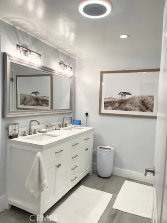 a bathroom with a double vanity sink and a mirror