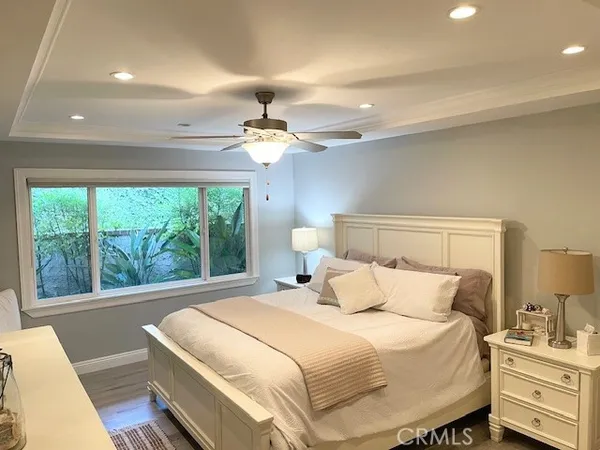 a bedroom with a bed and a large window