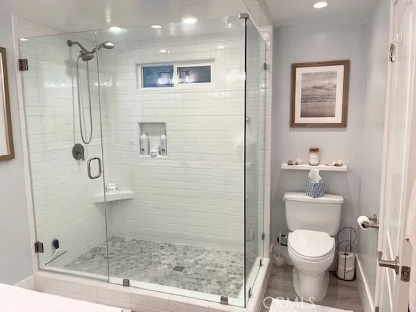 a bathroom with a toilet a sink and shower