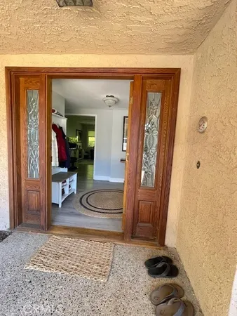 a view of a hallway with wooden floor and bedroom view