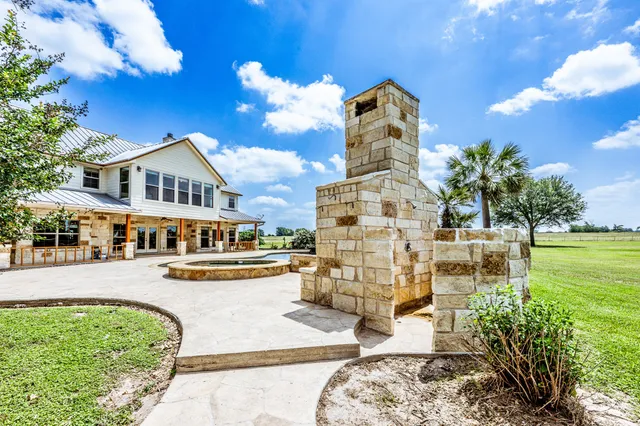 a view of a house with swimming pool and sitting area