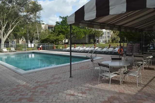 a view of a backyard with sitting area