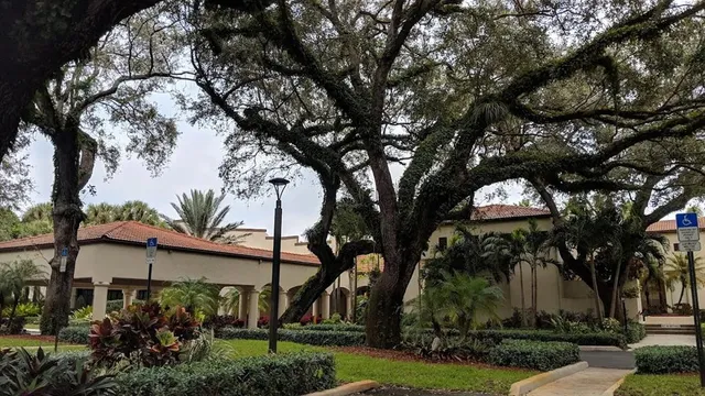 a view of a house with large trees