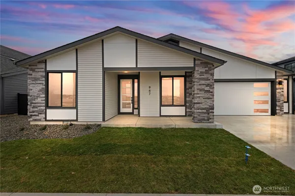 a front view of a house with a yard and garage