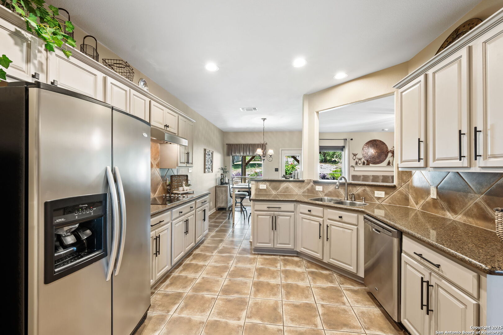14507 John David Helotes, TX 78023 - Photo 11 of 49 a kitchen with stainless steel appliances granite countertop a refrigerator and a sink