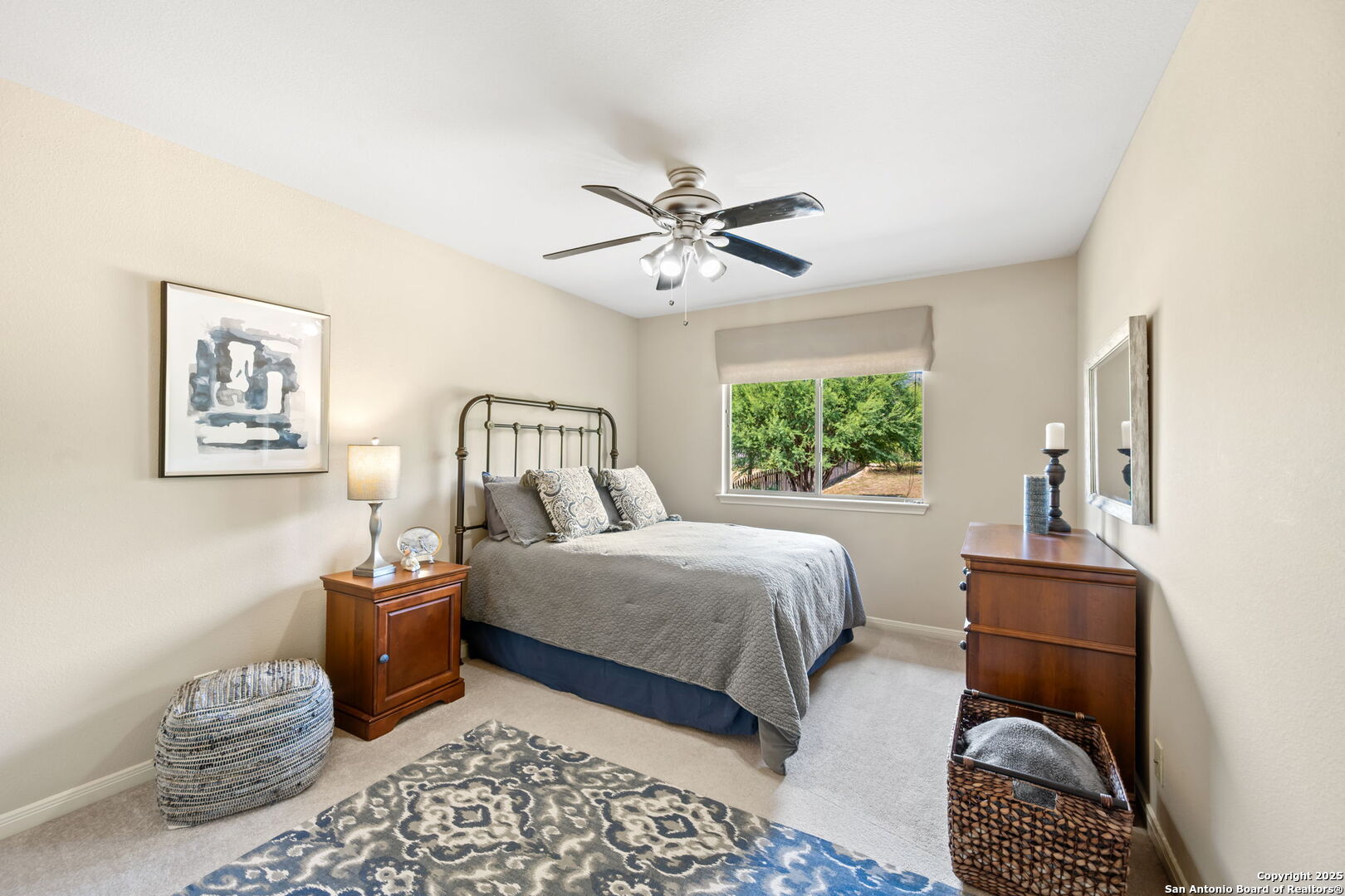 14507 John David Helotes, TX 78023 - Photo 17 of 49 a bedroom with a bed and a chandelier