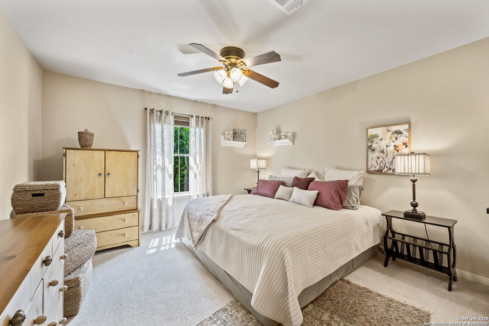 14507 John David Helotes, TX 78023 - Photo 19 of 49 a bedroom with a bed and a chandelier