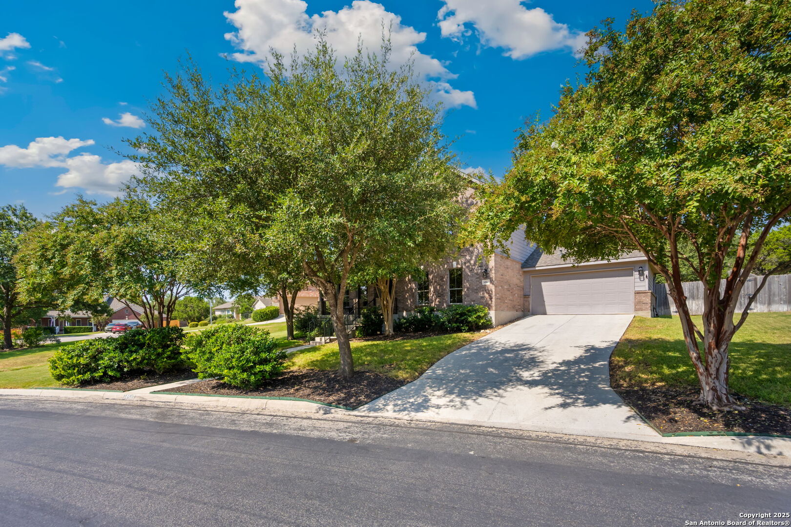 14507 John David Helotes, TX 78023 - Photo 33 of 49 a front view of a house with a yard and a garage