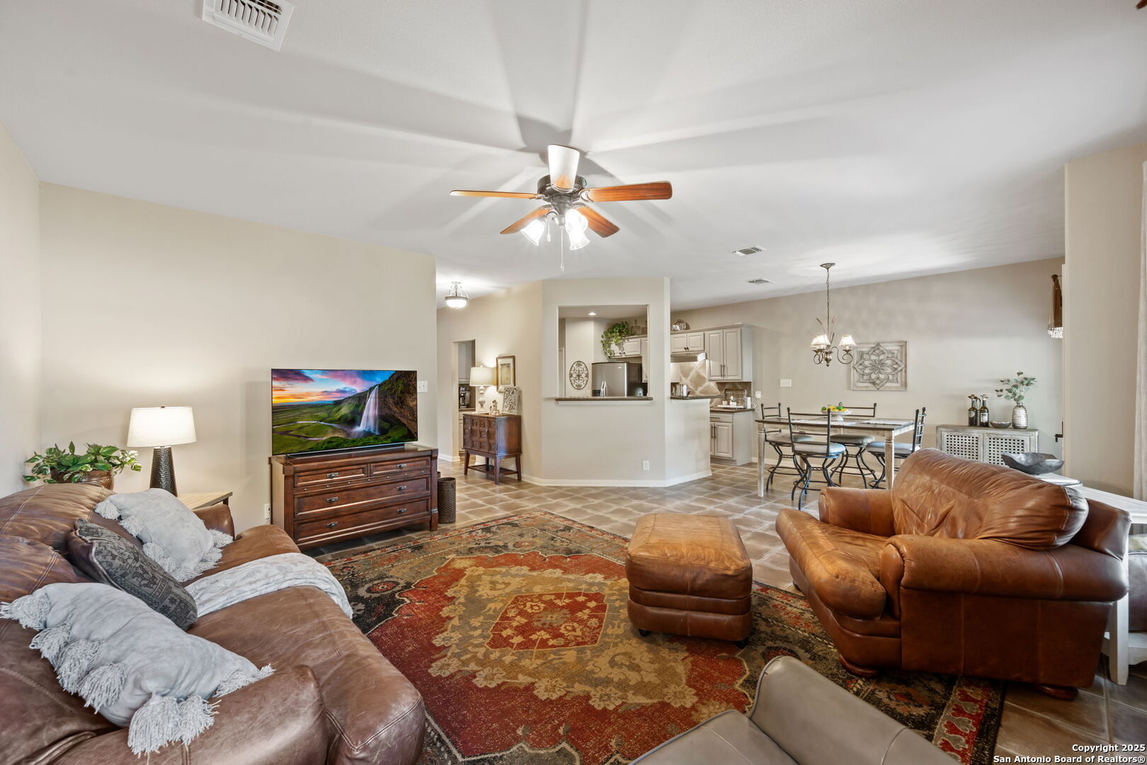 14507 John David Helotes, TX 78023 - Photo 37 of 49 a living room with furniture a ceiling fan and a flat screen tv