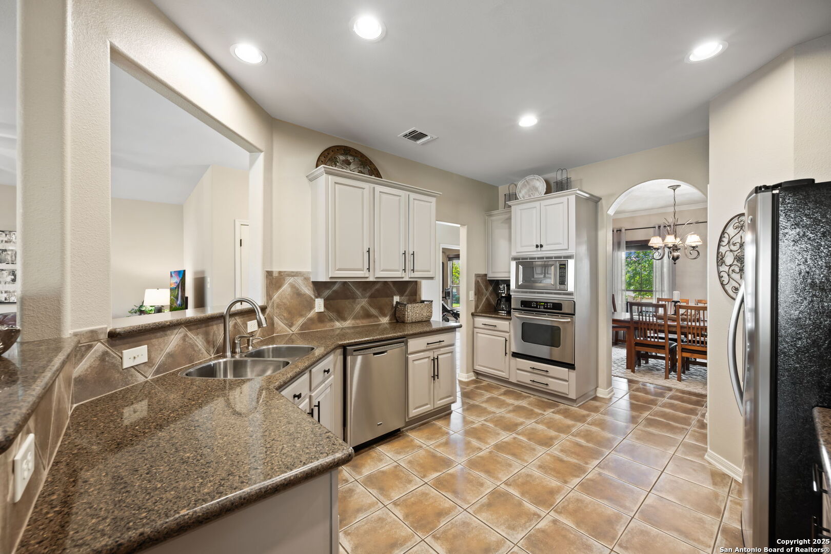 14507 John David Helotes, TX 78023 - Photo 38 of 49 a kitchen with stainless steel appliances granite countertop a sink and a refrigerator