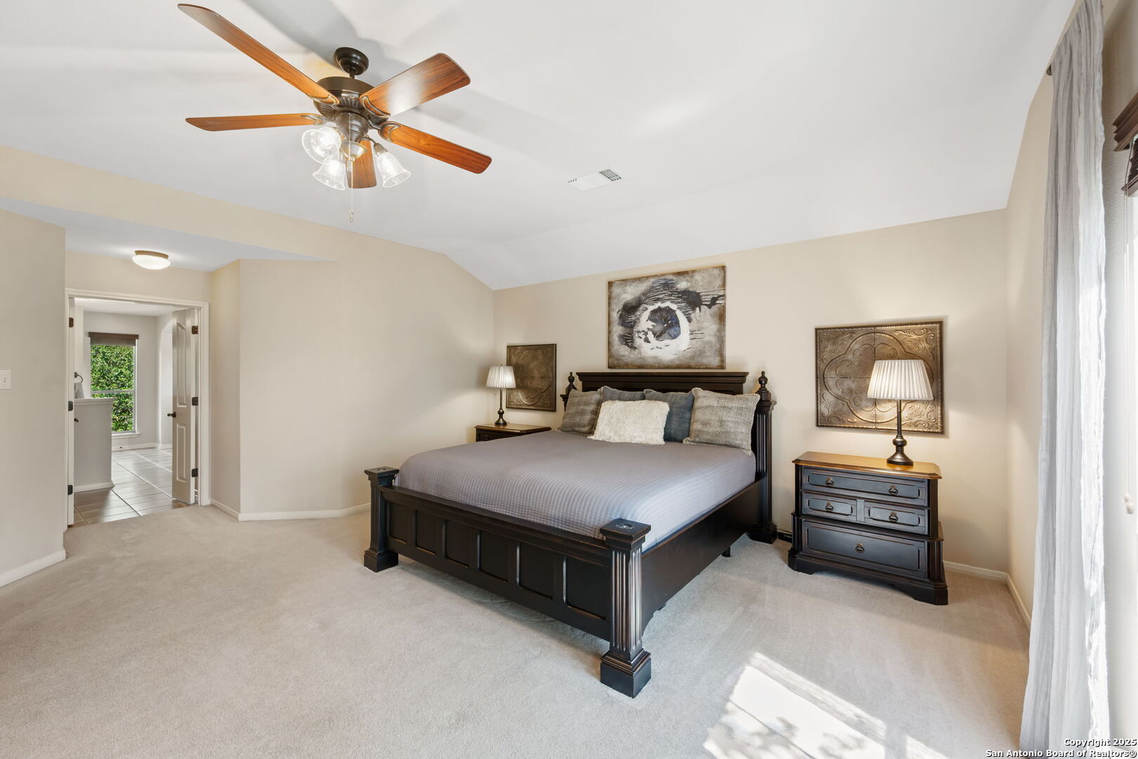 14507 John David Helotes, TX 78023 - Photo 40 of 49 a bedroom with a bed and a ceiling fan
