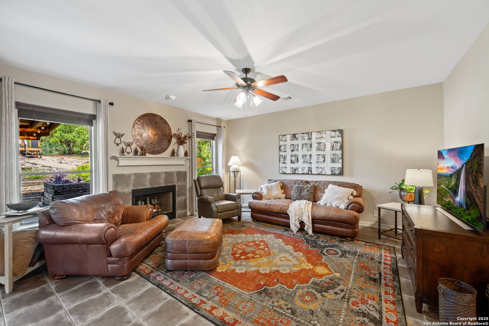 14507 John David Helotes, TX 78023 - Photo 8 of 49 a living room with furniture a fireplace and a flat screen tv