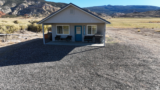 890 East Hatchery Road Bicknell, UT 84715 - Photo 6 of 48 View of front of house featuring a mountain view, stucco siding, and a patio