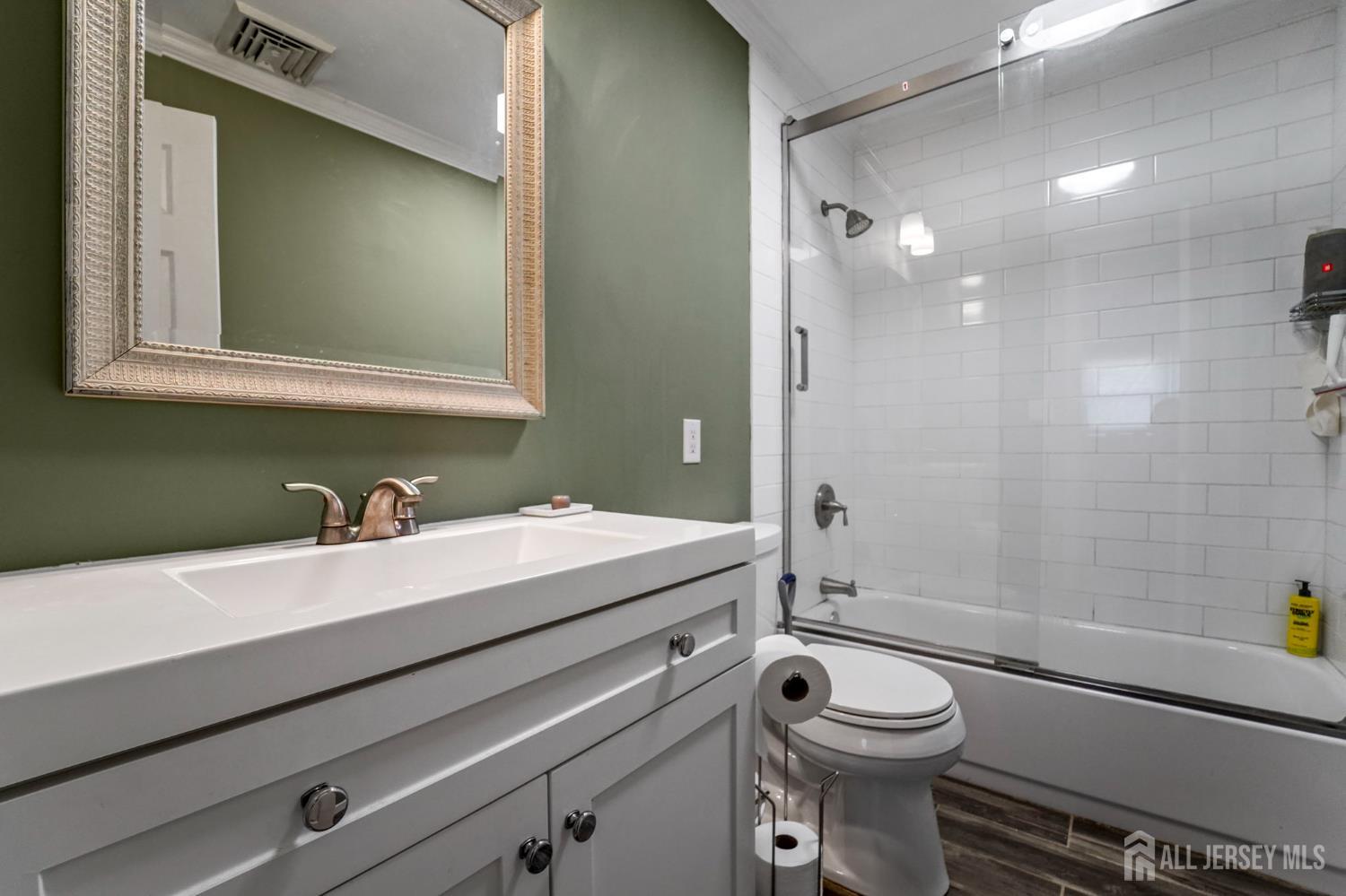 122 3rd Street Middlesex, NJ 08846 - Photo 19 of 24 a bathroom with a sink a toilet and shower