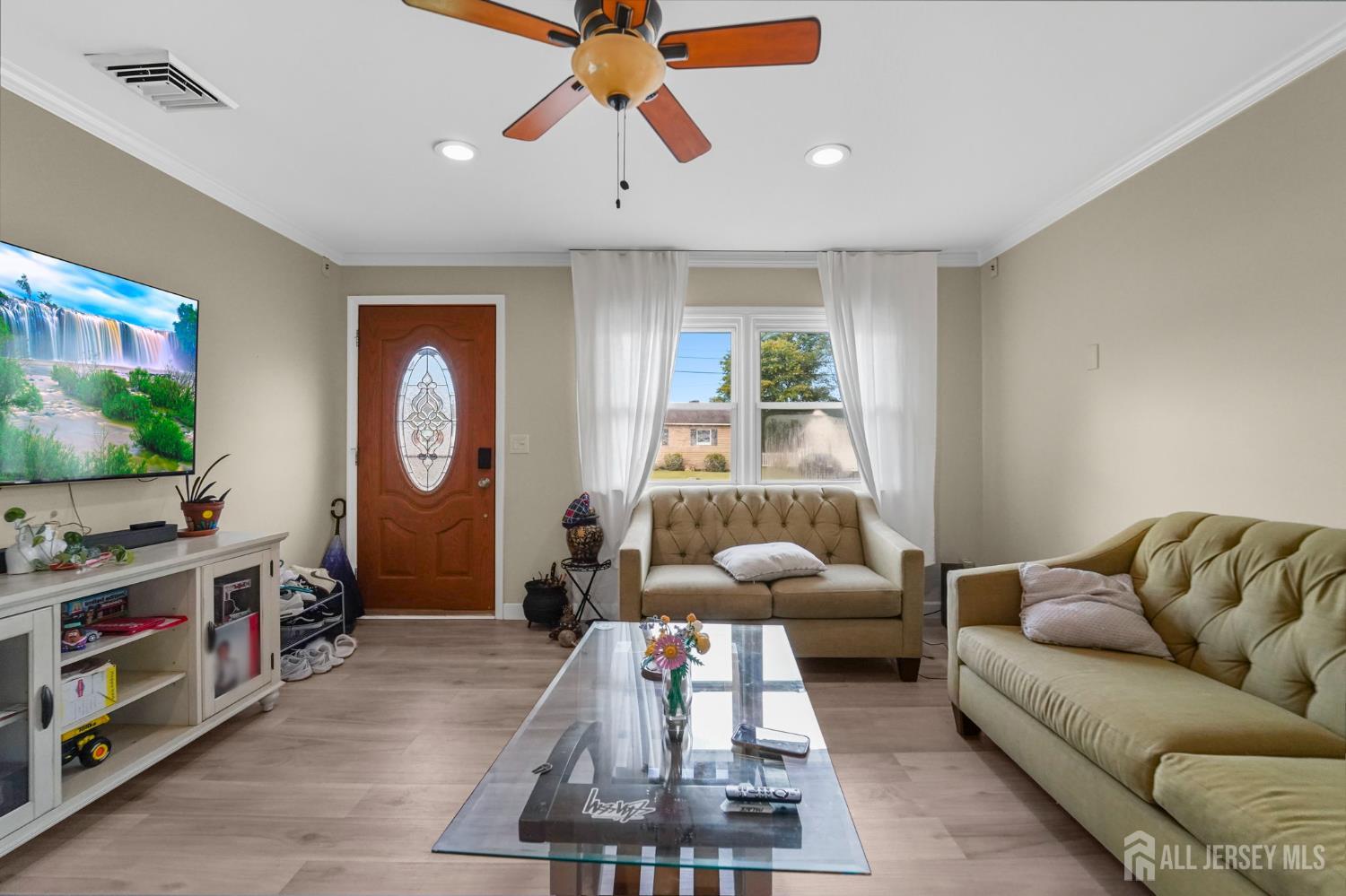 122 3rd Street Middlesex, NJ 08846 - Photo 5 of 24 a living room with furniture a flat screen tv and a window