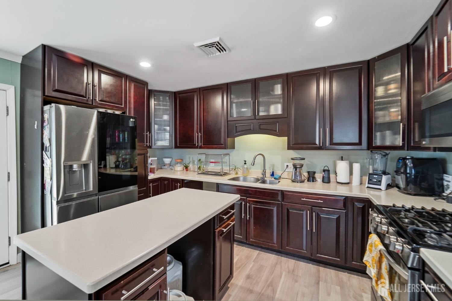 122 3rd Street Middlesex, NJ 08846 - Photo 6 of 24 a kitchen with a stove a sink a refrigerator and cabinets